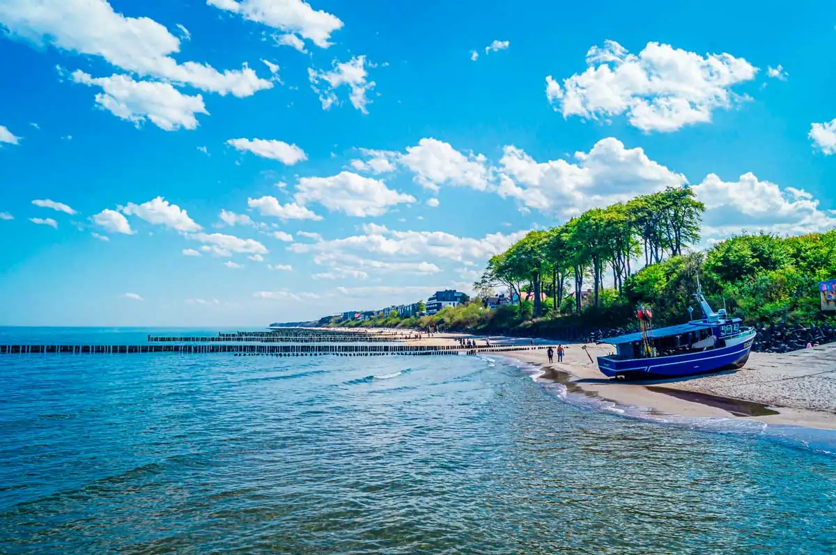 Ostseestrand in Ustronie Morskie mit Fischerboot an der Küste