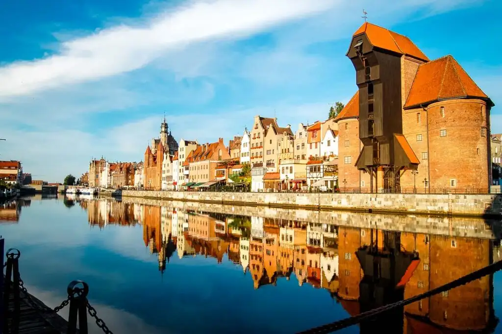 Das Krantor in Danzig mit Blick auf die Mottlau, umgeben von historischen Gebäuden.