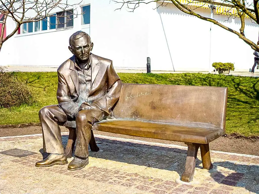 Gedenkbank von Gustaw Holoubek auf dem Walk of Fame in Międzyzdroje mit umliegenden Handabdrücken bekannter polnischer Schauspieler